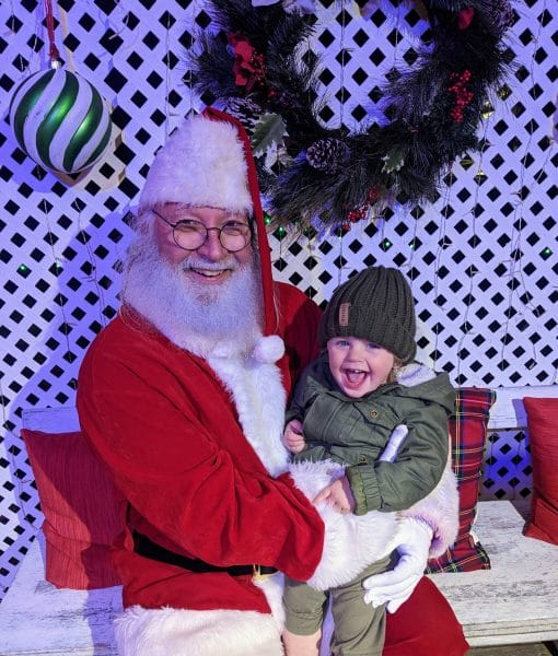 Child Sitting on Santa's Lap at The Lights of Christmas in Virginia Beach