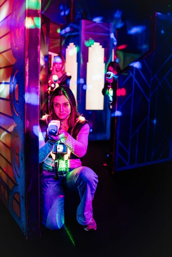 Woman playing laser tag - illustrating Apex Entertainment VB School Break Ideas